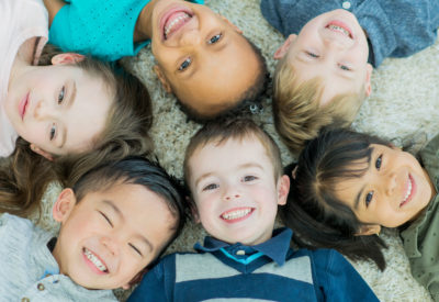 Smiling happy three 3 year old pre-school child toddler playing