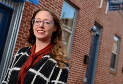 woman standing in front of row houses