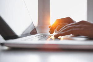 Hands typing on keyboard