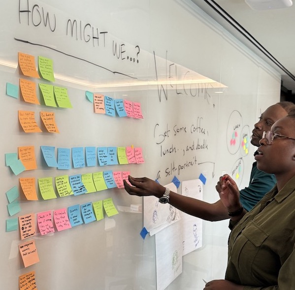 person in front of board with notes