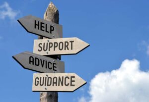 Sign post with signs for Help, Support, Advice and Guidance